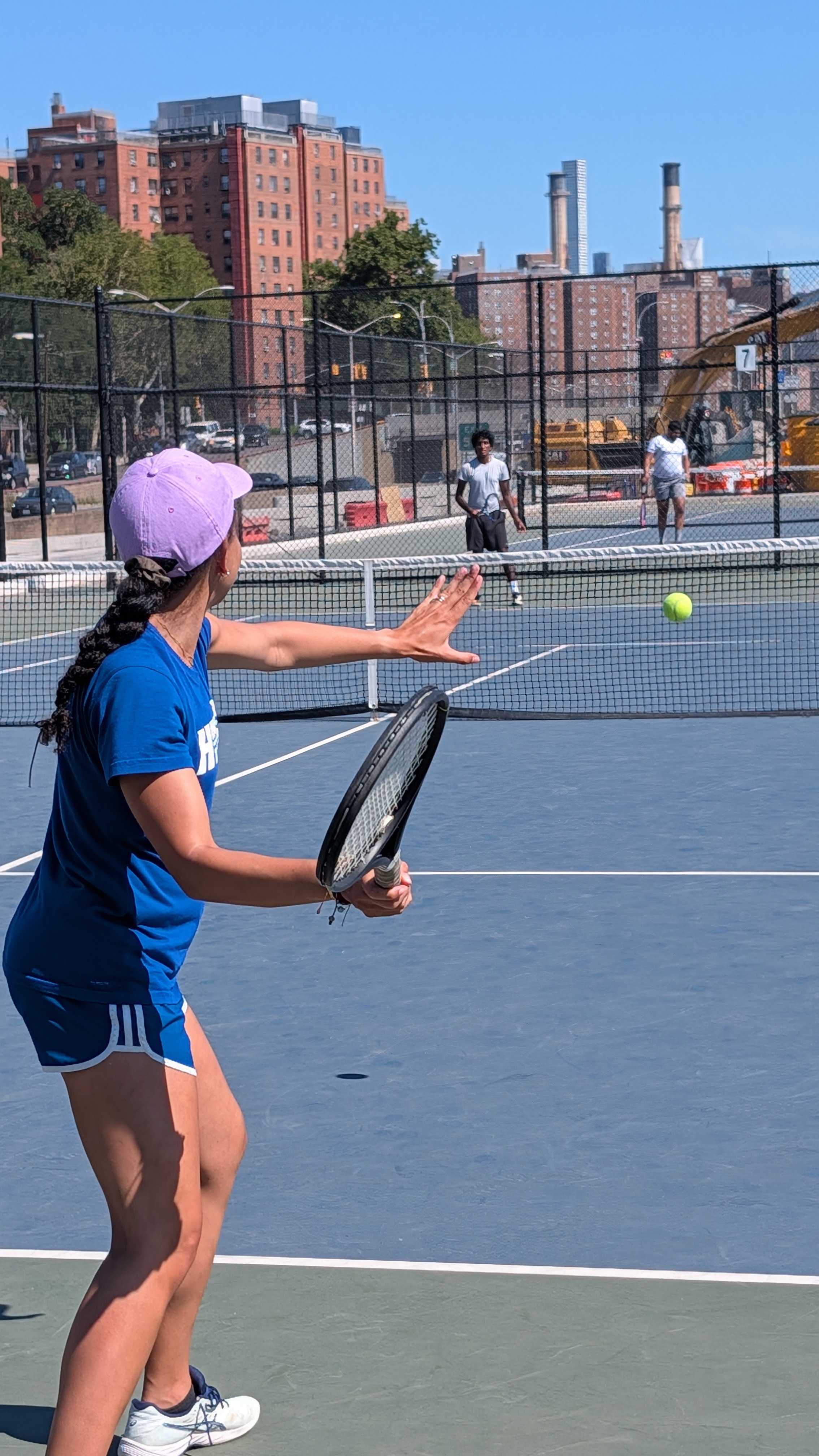 A player returning a ball at a New York City tennis court