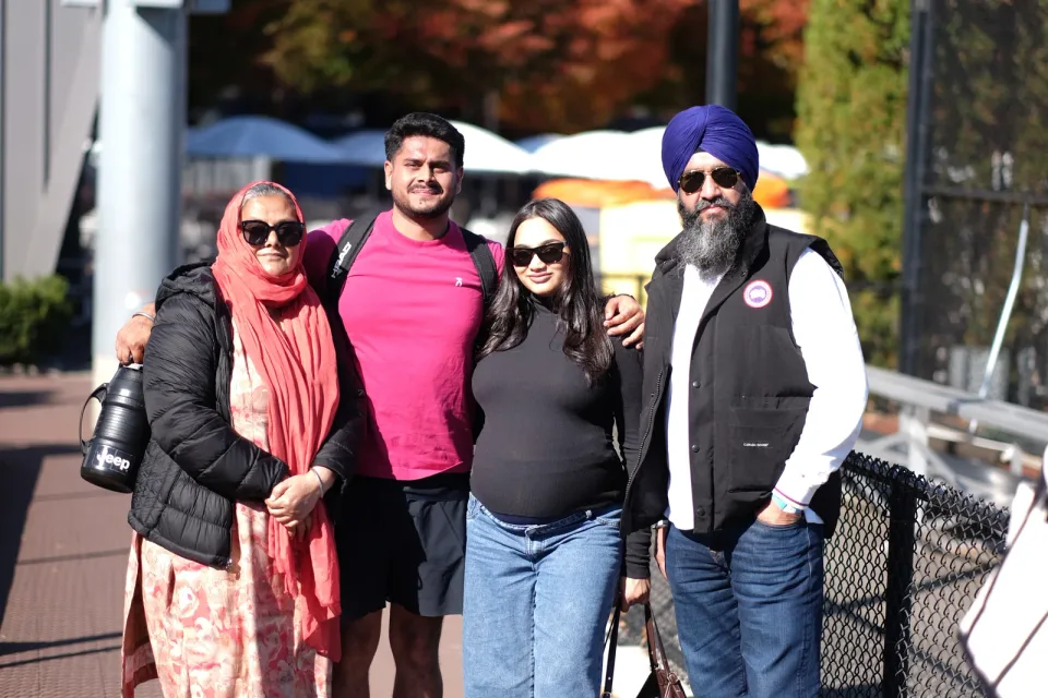 Friends and family share a photograph beside the courts at the 2026 Manhattan Ladder Finals