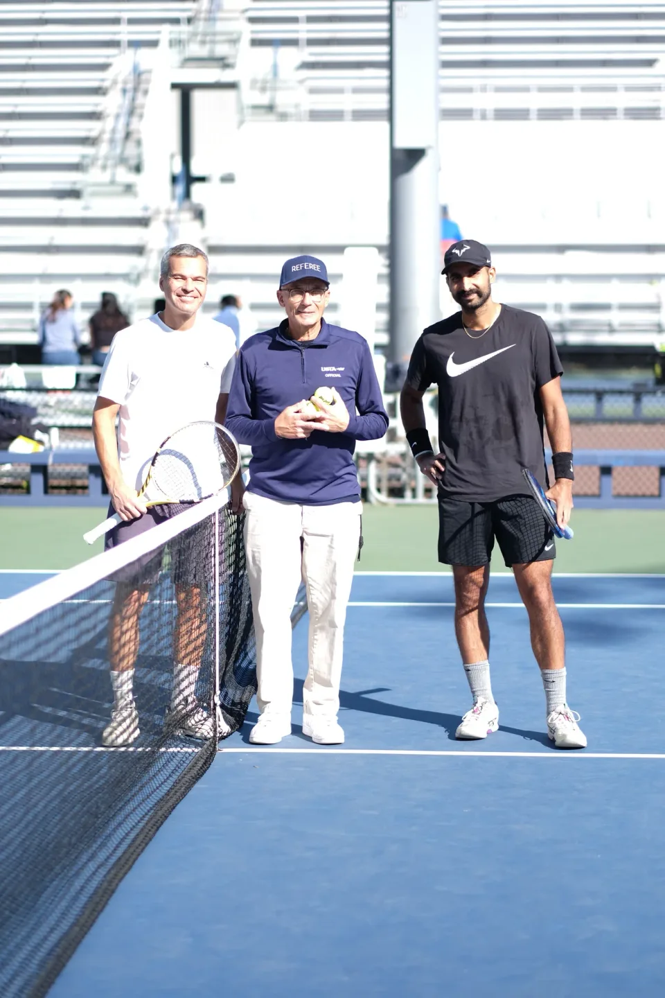Players and an official together at the net at the 2026 Manhattan Ladder Finals