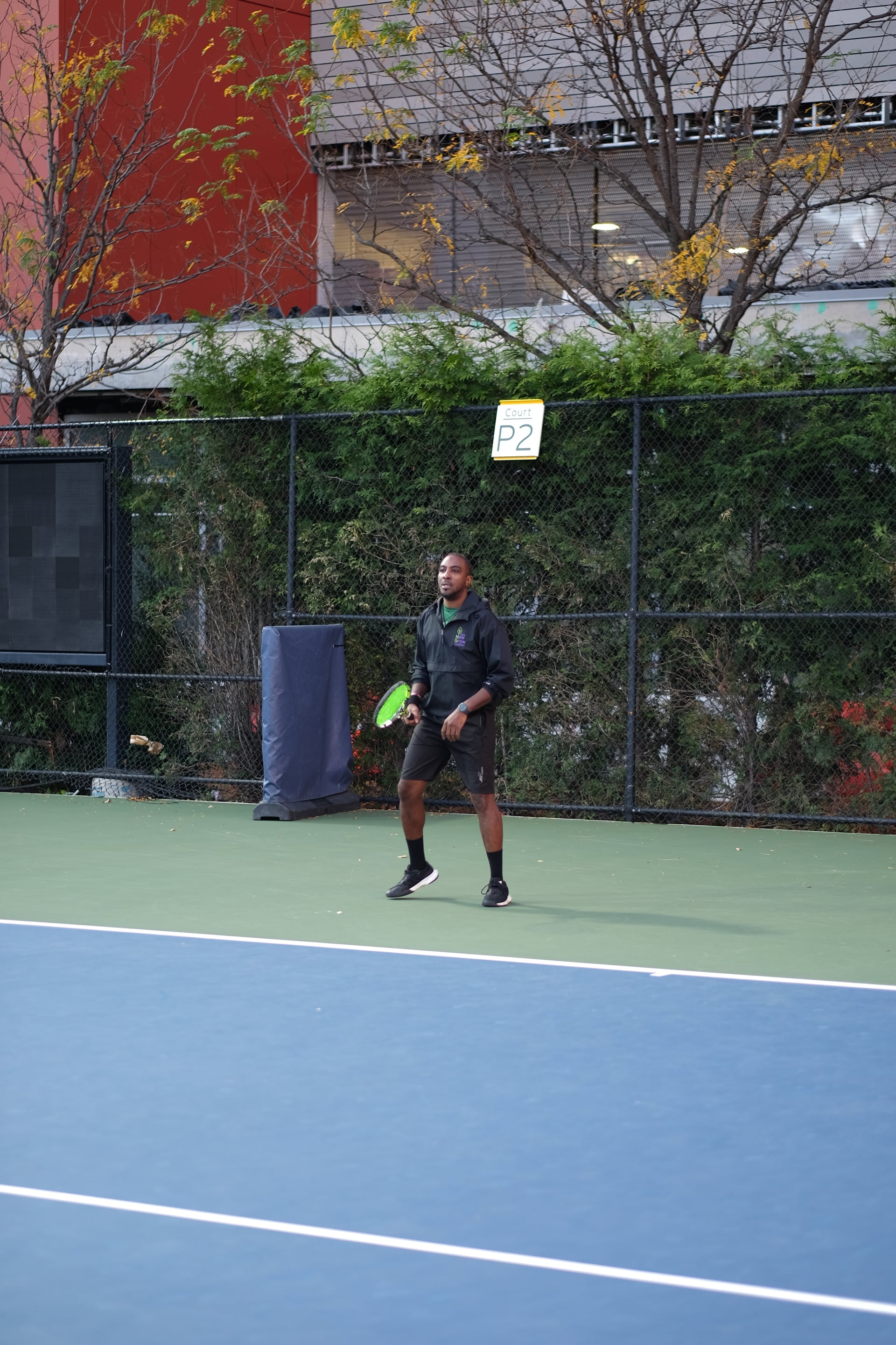 A player preparing for the next point on practice court P2 at Saturday Sunset Club, October 17, 2026
