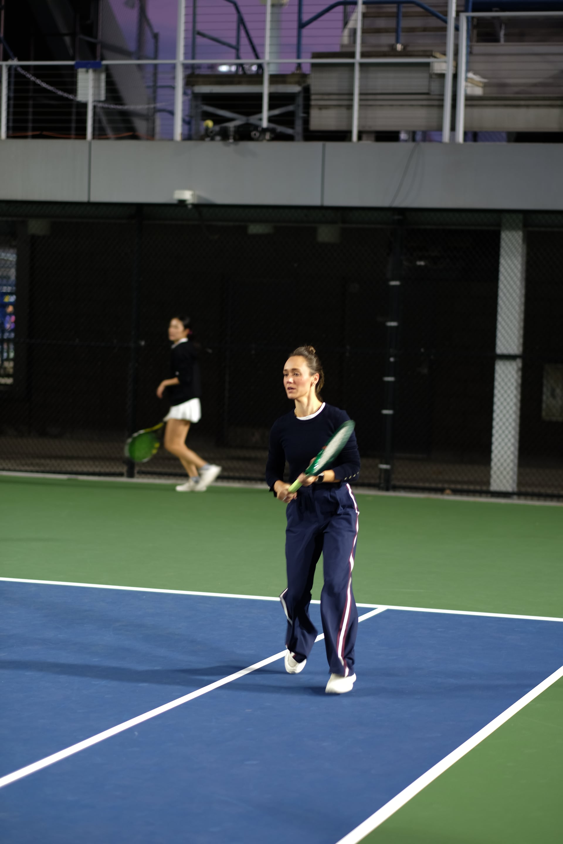 A player following a rally under the evening lights at Saturday Sunset Club, October 17, 2026