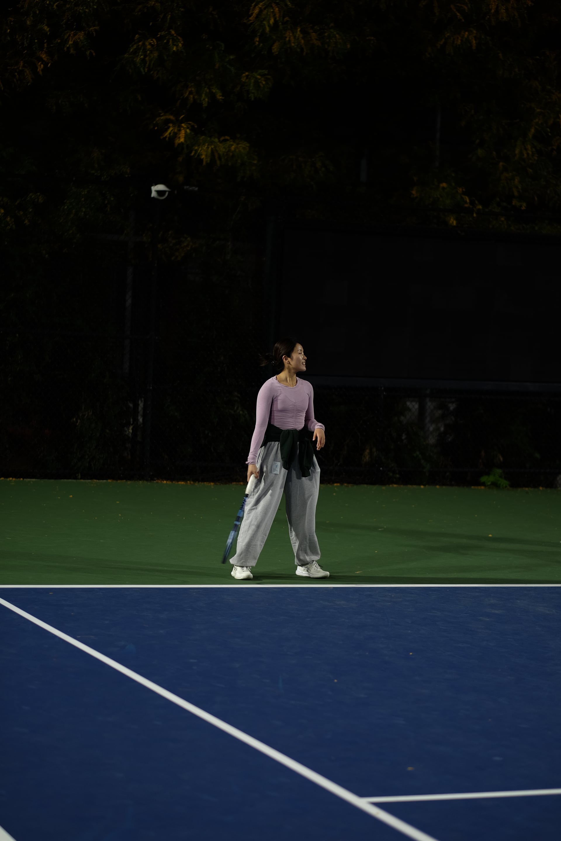 A player between points on the floodlit outdoor courts at Saturday Sunset Club, October 17, 2026