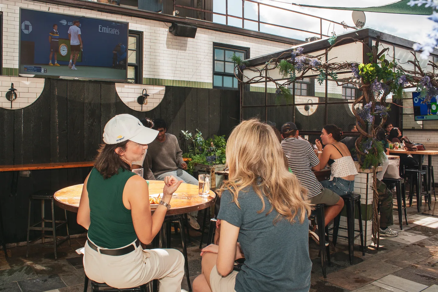 Guests seated together beneath the rooftop television