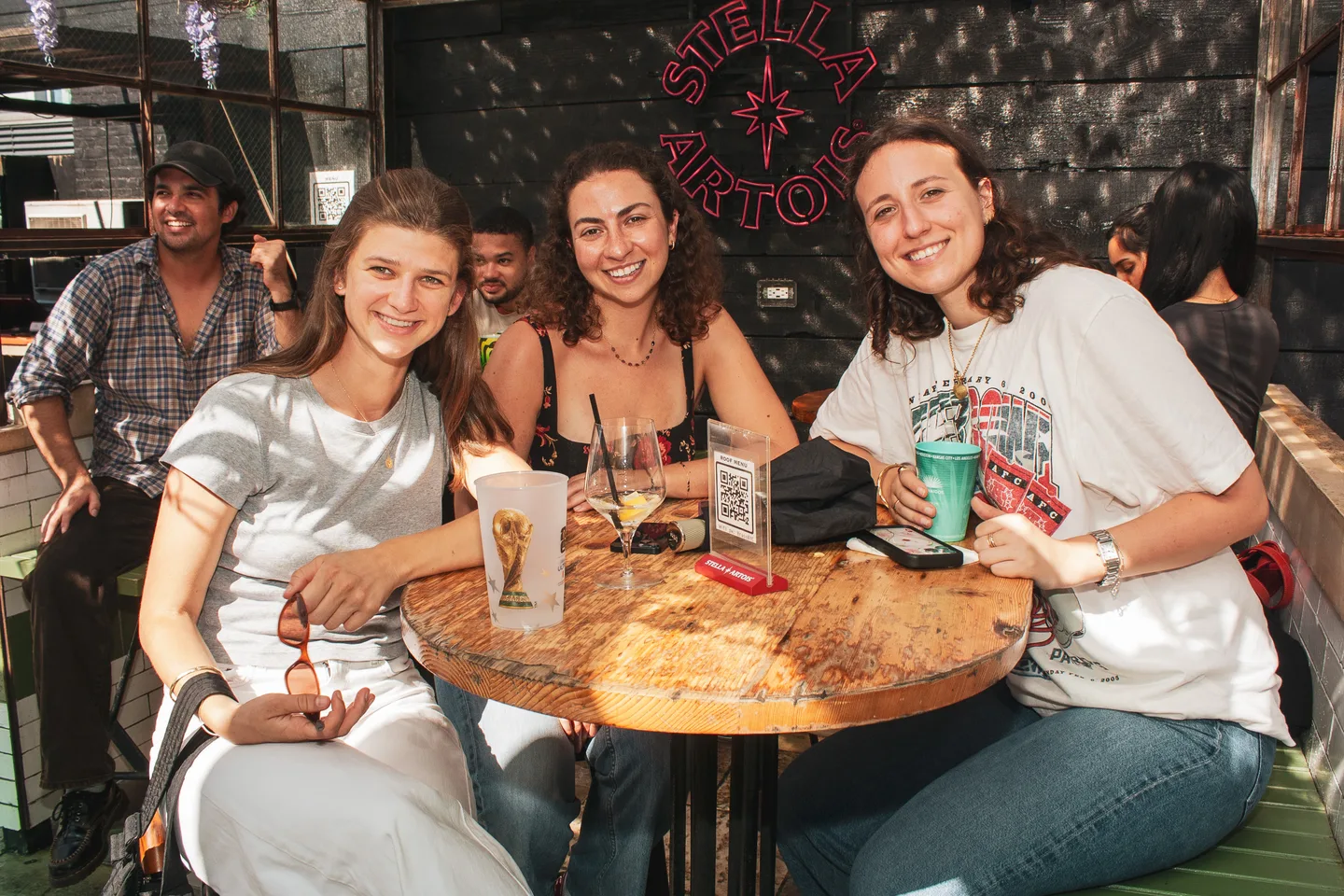 Friends gathered around a table on the rooftop