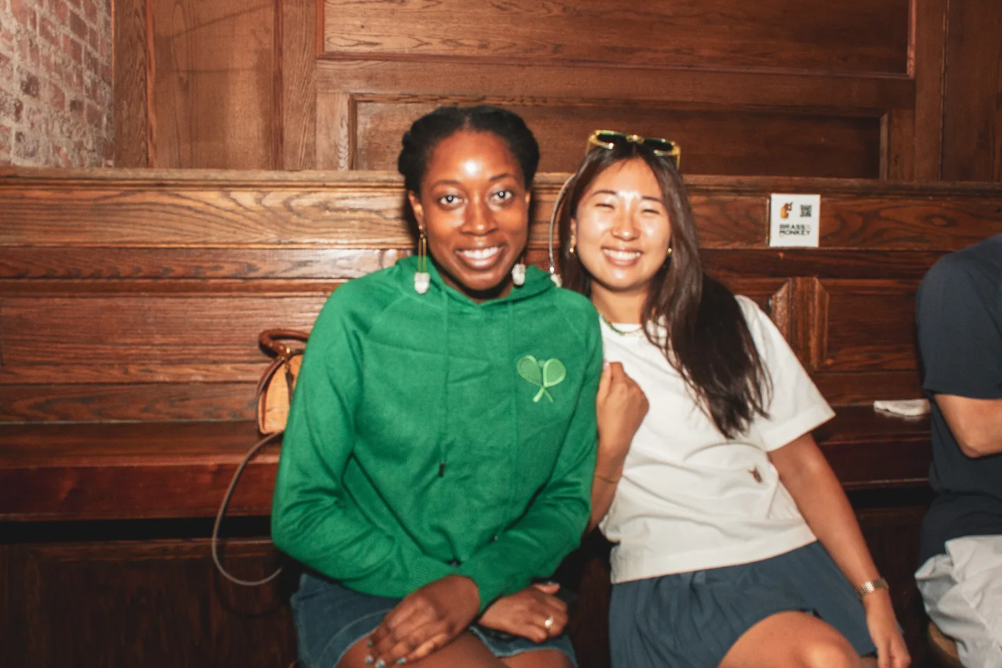 Two guests smiling together during the watch party
