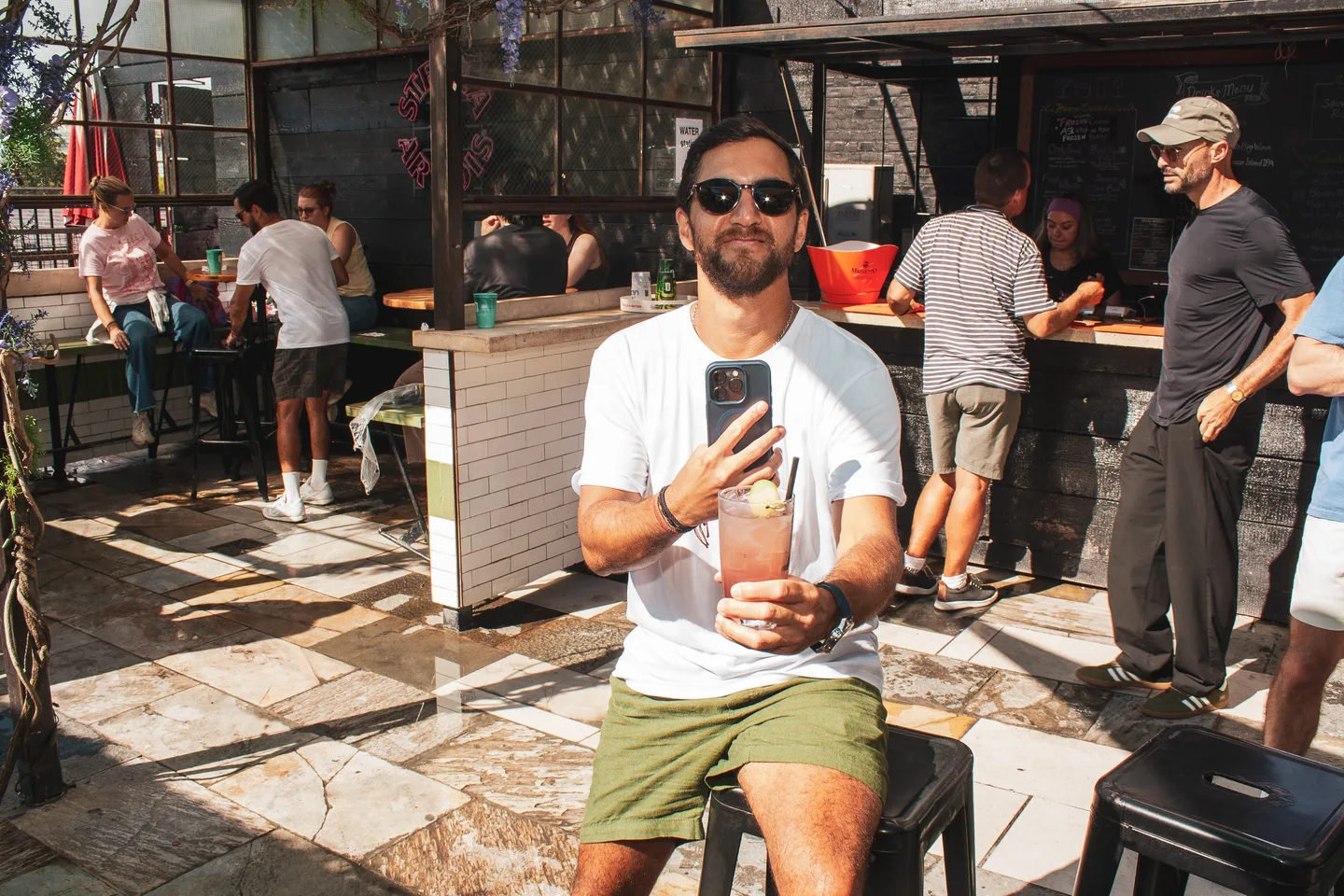 Guest holding a drink in the Brass Monkey rooftop space