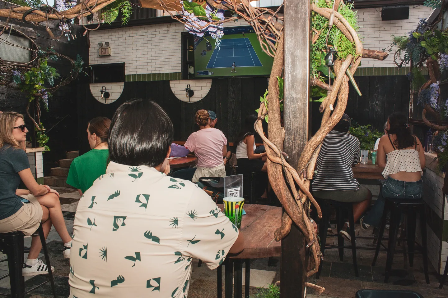 Guests watching the match in the decorated rooftop space