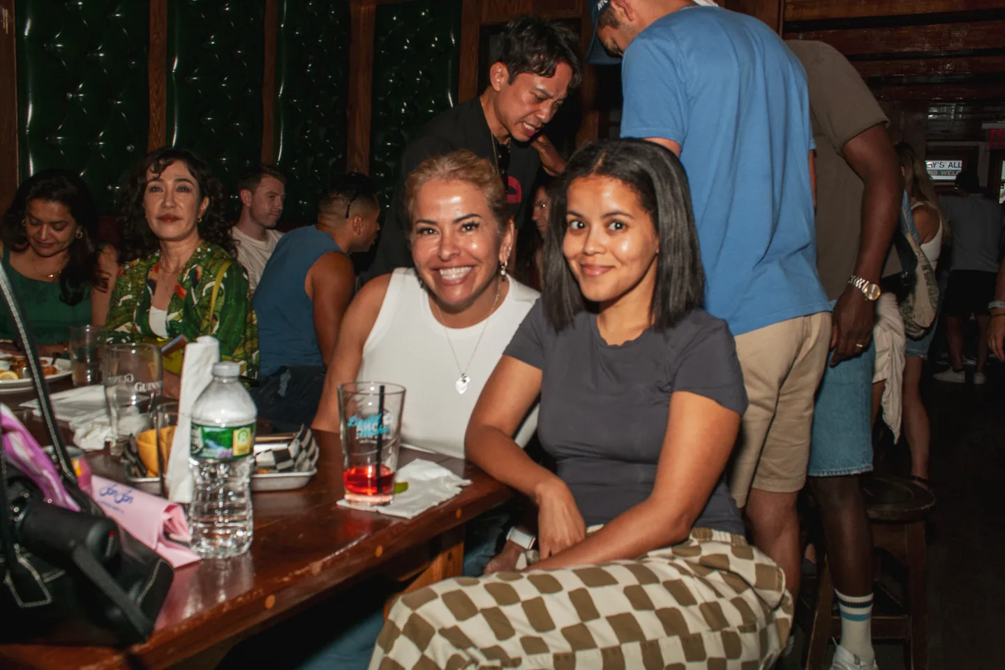 Guests smiling together at a table during the event