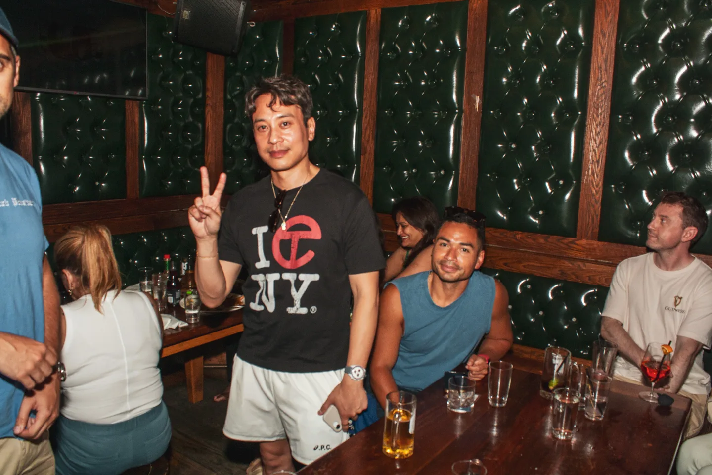Guests posing together in a booth at Brass Monkey
