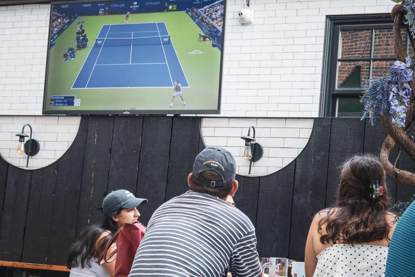 Guests watching the tennis match on the big screen