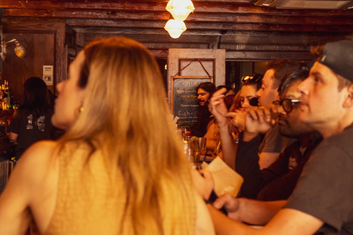Guests gathered around a table inside Brass Monkey