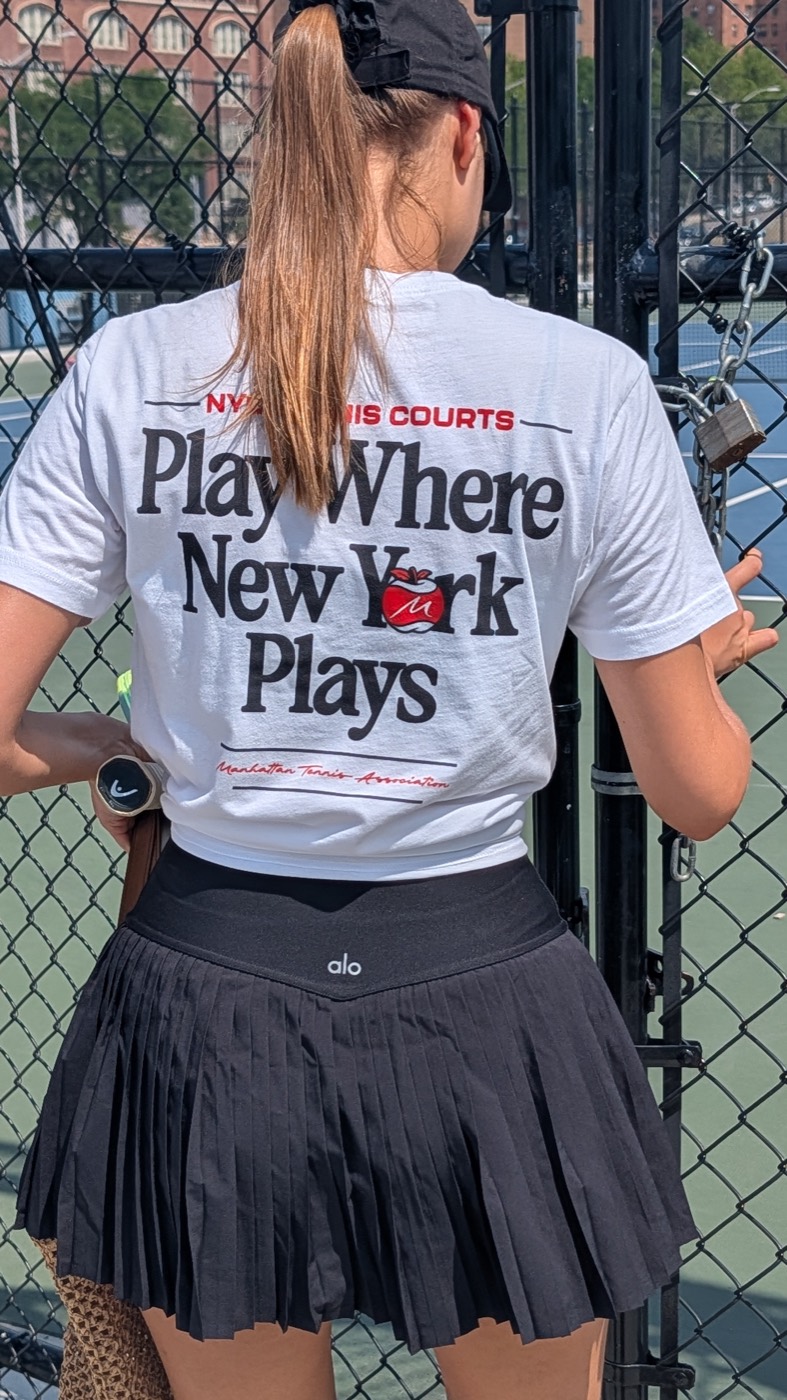 Manhattan Tennis Association shirt on a player at a New York City tennis court